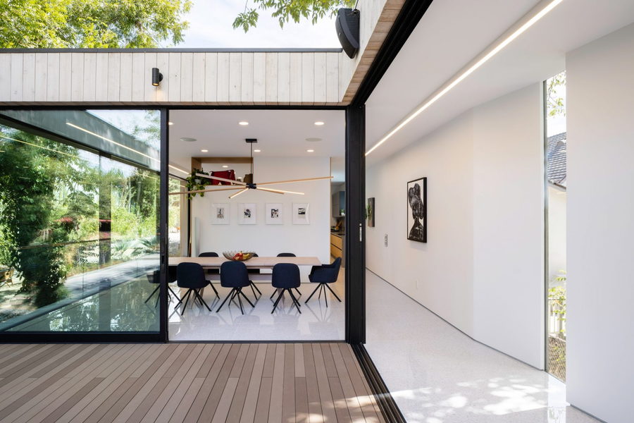 Trasitional spaces like this one exist all around the low-footprint Bridge House,