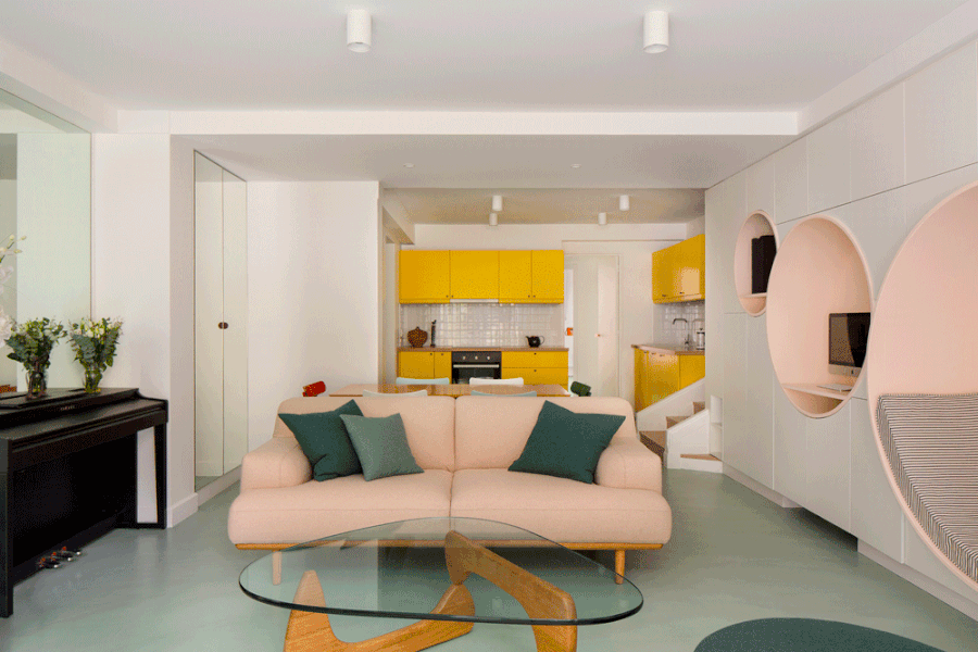 The living room of a Neuilly-sur-Seine apartment renovated by Atelier Pierre Louis Gerlier, complete with circular reading nooks and a pastel color palette.