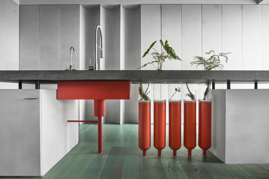 Repurposed gas canisters and greenery bring this minimalist workspace to life. 