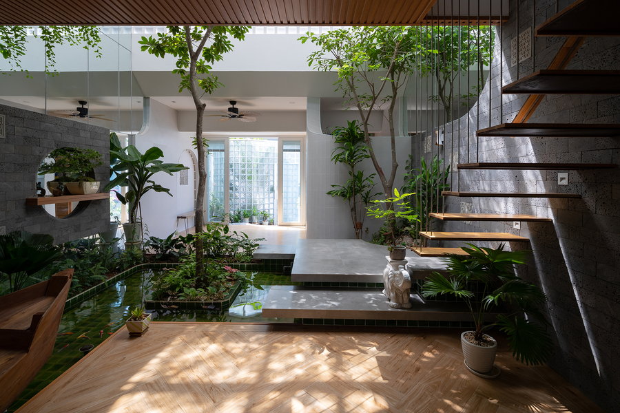 Floating stairs lead to a lower-level garden in Vietnam's tranquil Coco House.