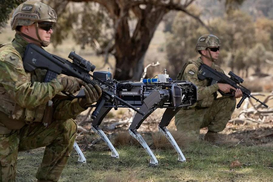 Ghost Robotics' robo-dog stands alongside members of the US military.