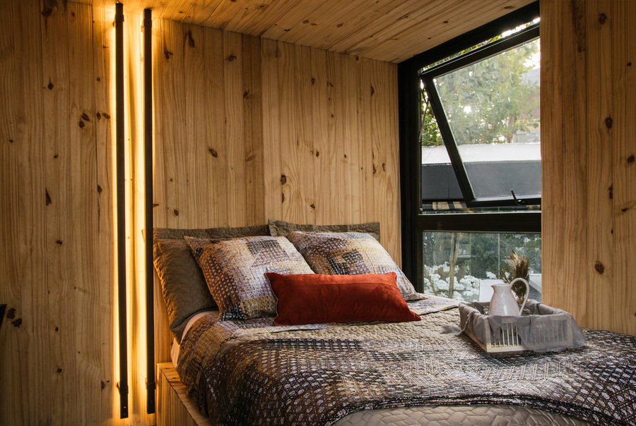 Simple, well-lit bedroom space on the upper level of the Cabana portable tiny home. 