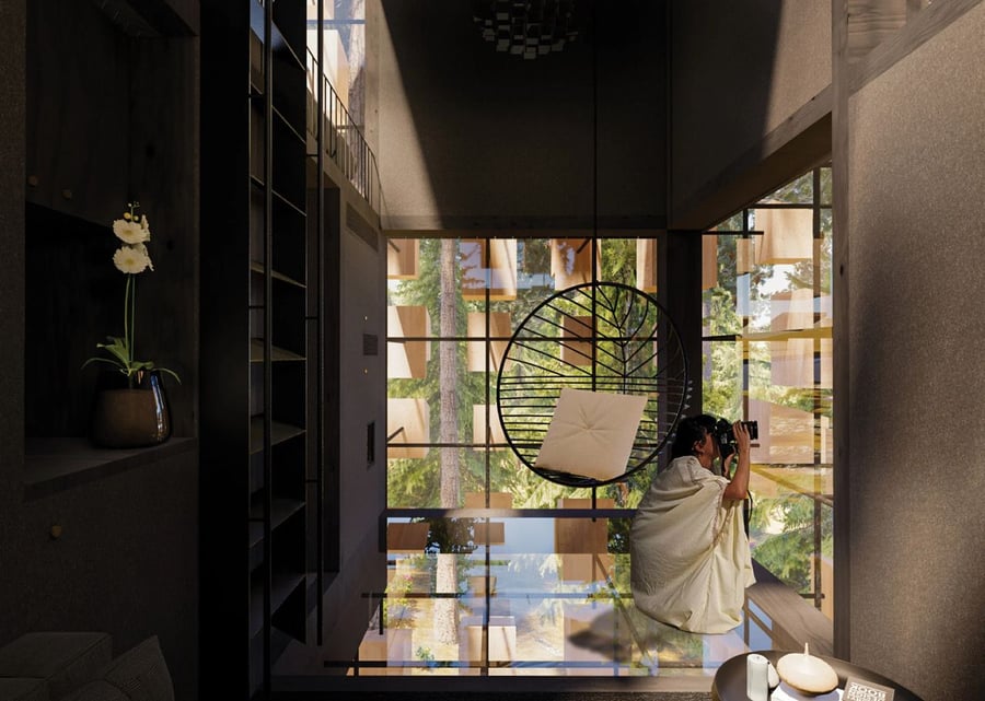 Guest uses binoculars to watch birds inside the BIG-designed Biosphere treehouse. 