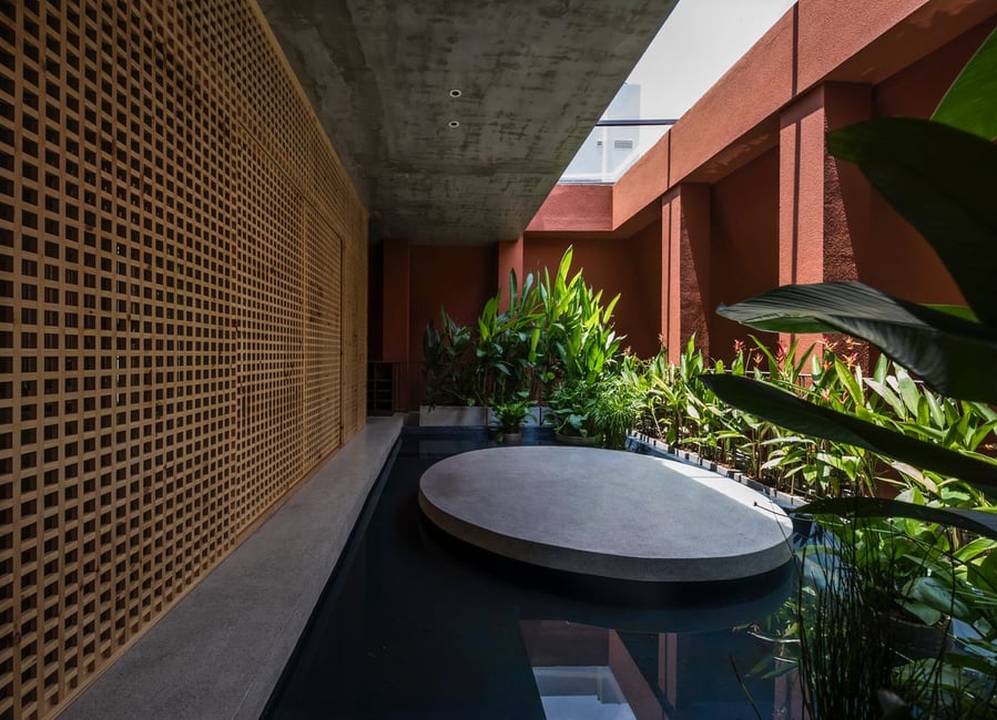 Tranquil outdoor courtyard worked into Ho Chi Minh City's Red Cave House. 