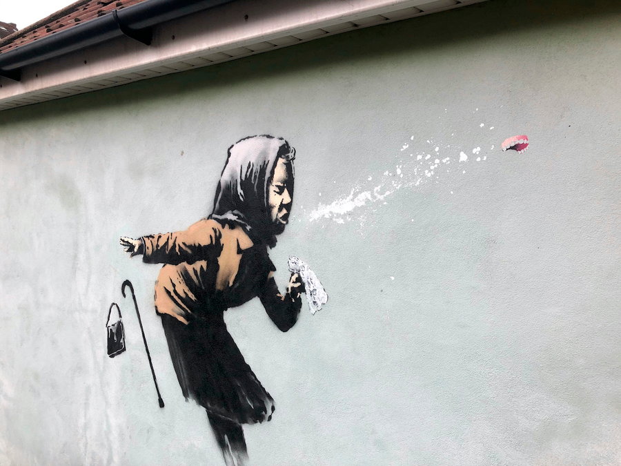 Large Banksy mural of an elderly woman sneezing so hard her dentures fly out.