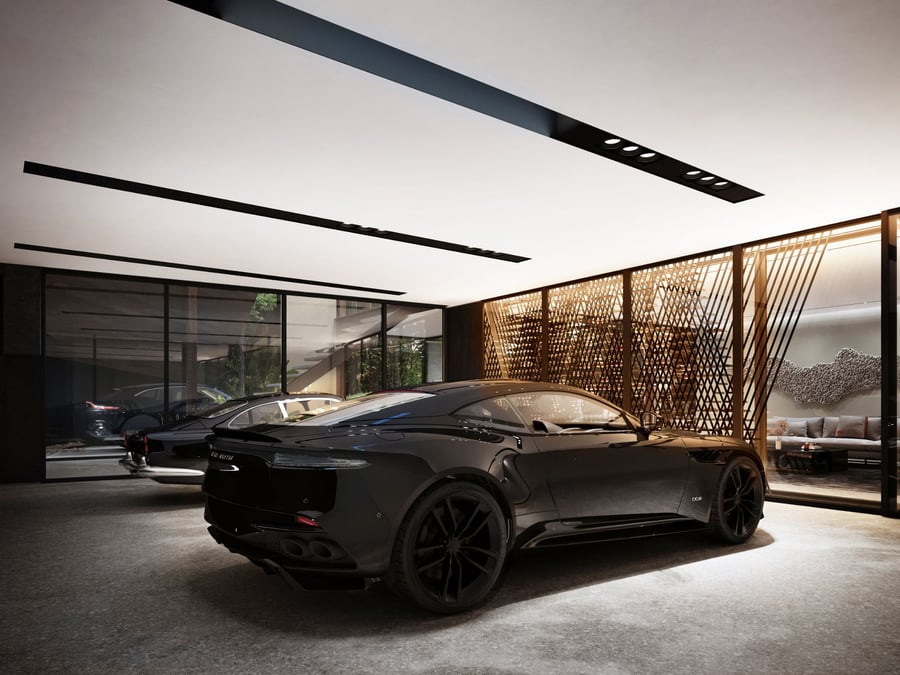 A sleek black Aston Martin sportscar sits in the automotive gallery inside the company's lavish Sylvan Rock home in New York.