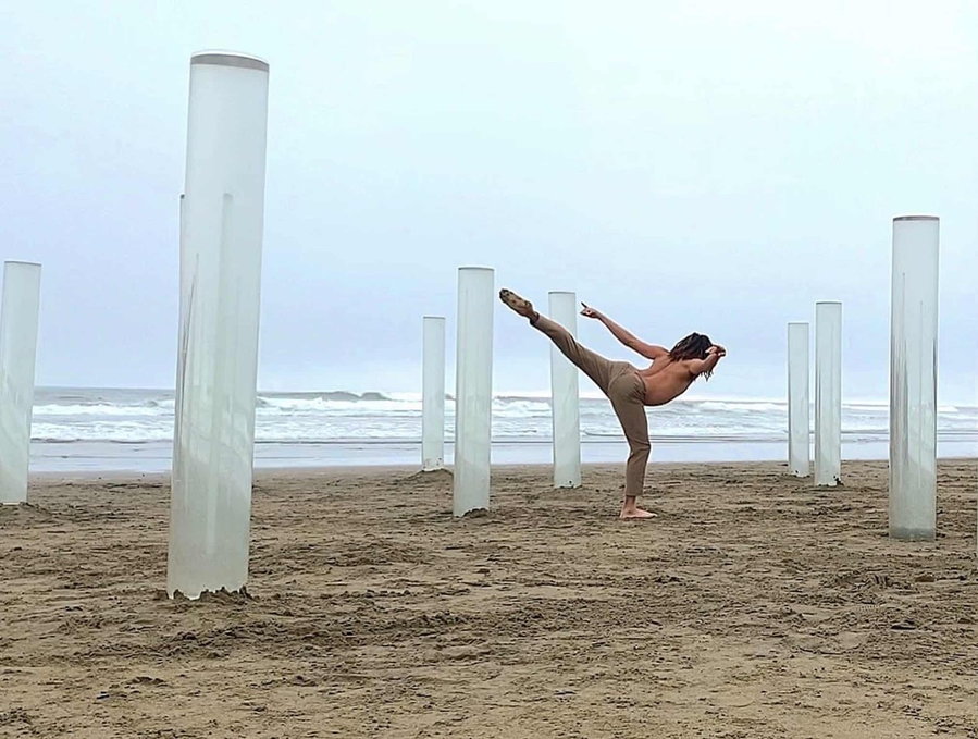 Person dancing between the pillars that comprise Ana Teresa Fernández' 
