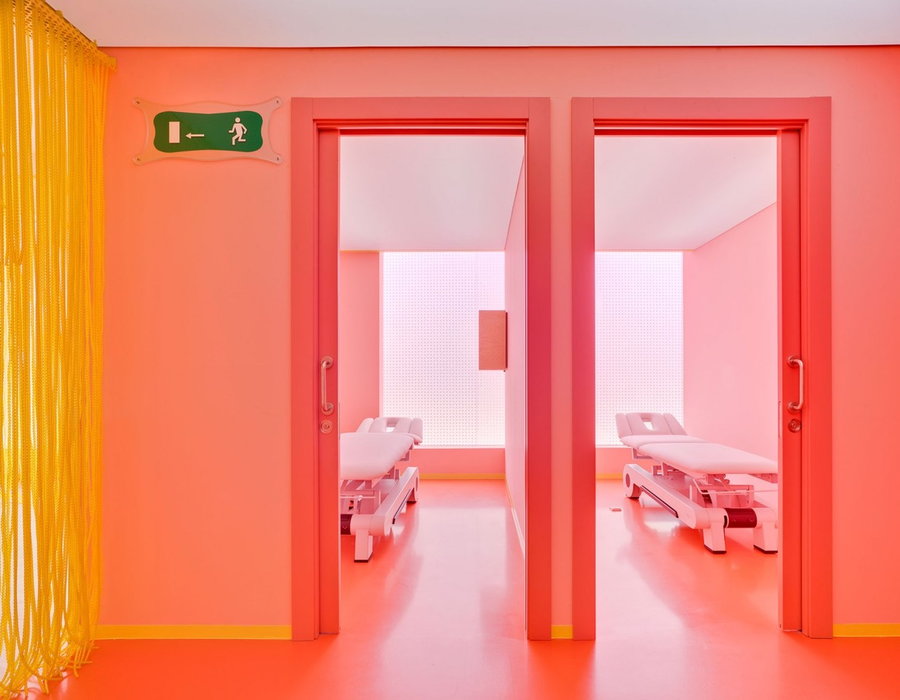 Darker shades of pink and orange in the clinic's hallways help people feel energized as they make their way to their next destination. 