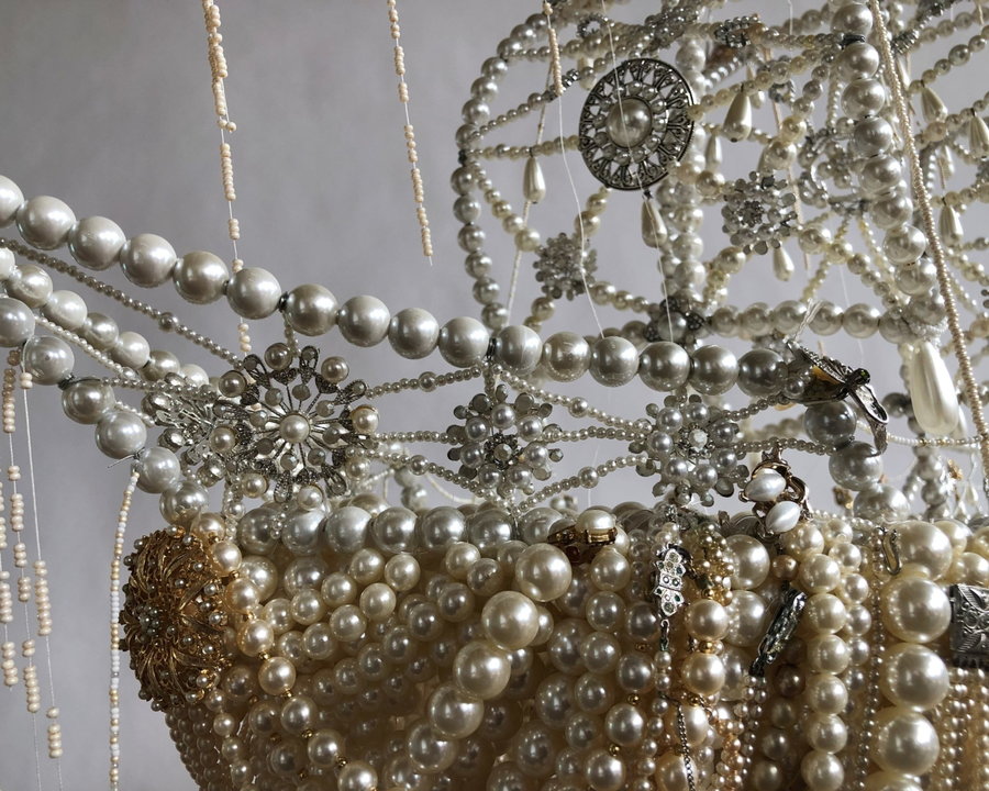 Close-up view of a dazzling upcycled pearl ship by artist Ann Carrington. 