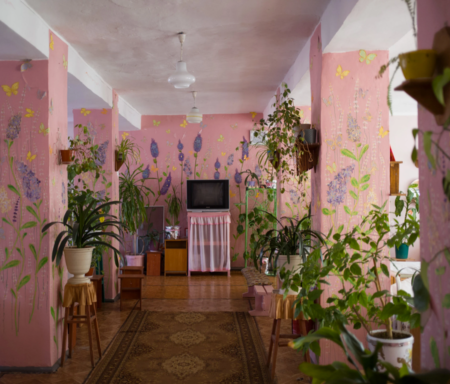 A bright pink television room inside a Ukrainian women's prison. 