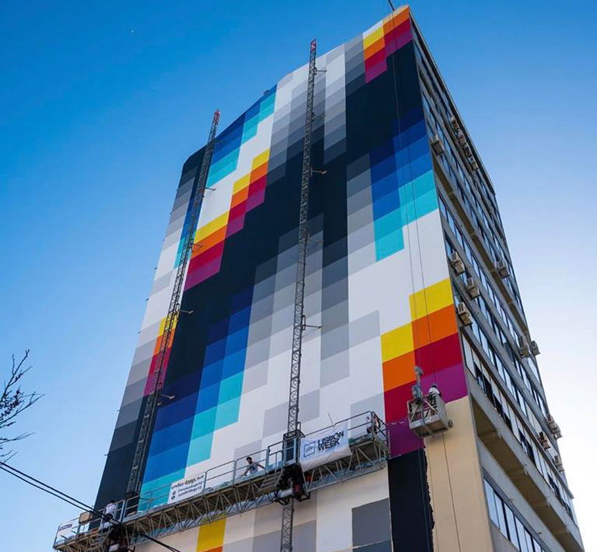 Colorful mural by Felipe Pantone on the facade of a building in Portugal.