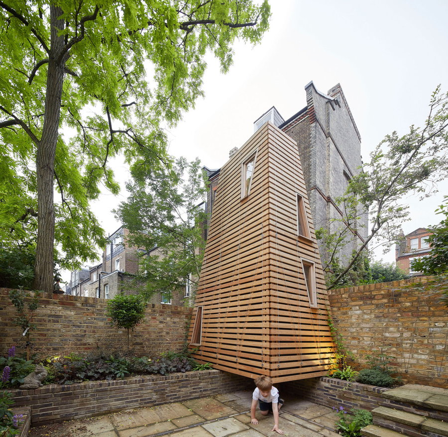 Small child plays outside the entrance to the Penfold treeless treehouse in London.