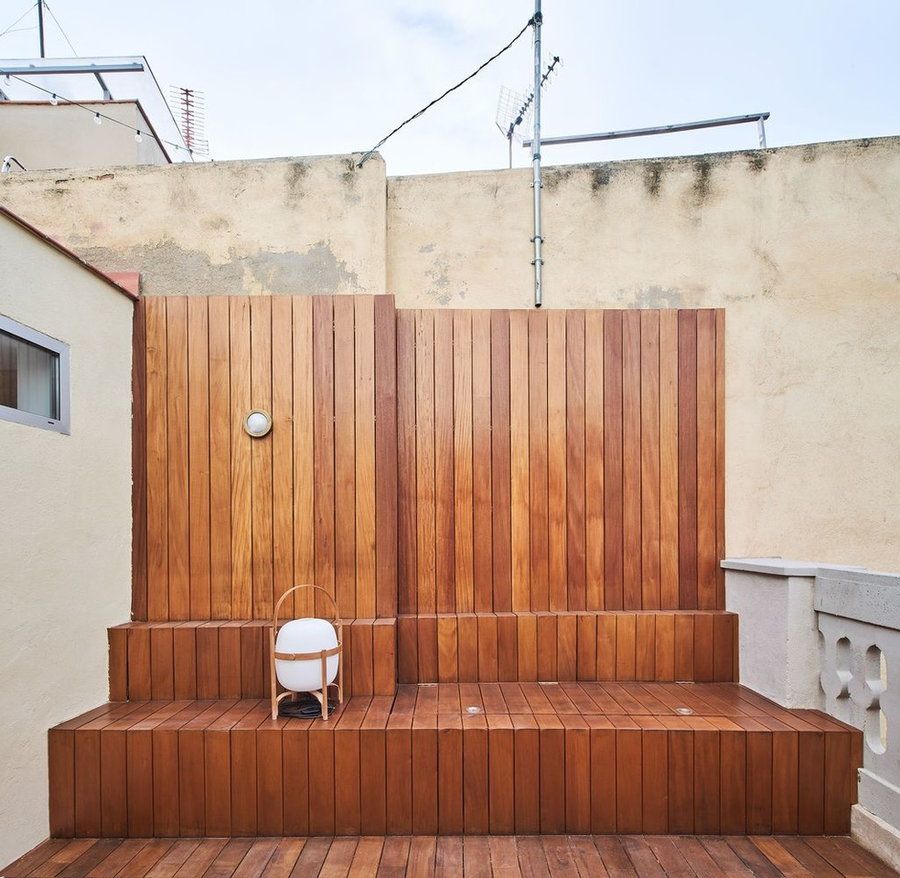 Wooden rooftop terrace tops off the renovated BSP 20 apartment in Barcelona.
