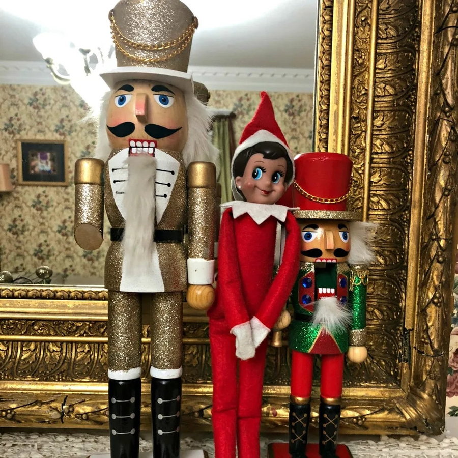 Elf on the Shelf hides between two classic Nutcracker figures. 