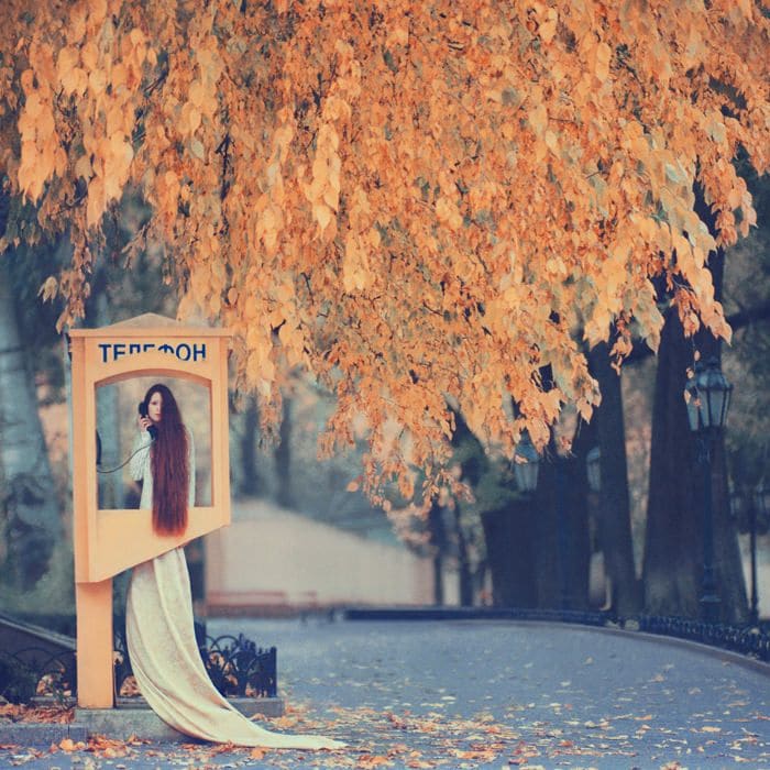 Surreal photograph by Ukrainian artist Oleg Oprisco shows a woman using a forest phone booth.
