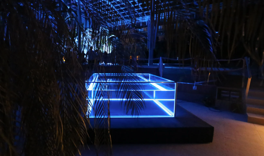 The LED lights around the perimeter of the Nautilus glass hot tub shine an inviting blue light out into the night.