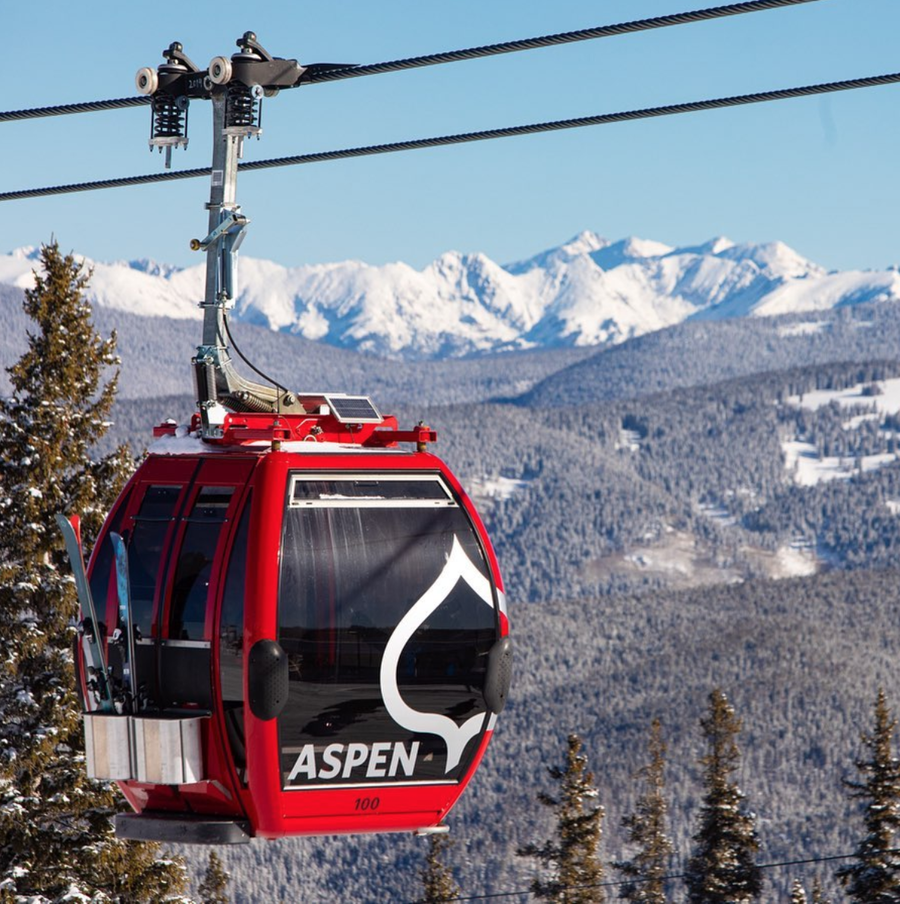 Red gondola goes up the chair lift at Colorado's Aspen Mountain.