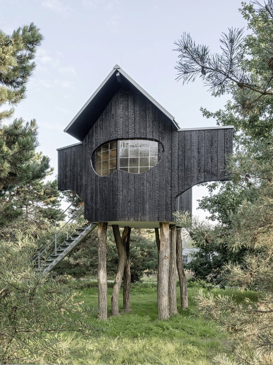 Exterior shot of architect Terunobu Fujimori's Ein Stein Tea House, a fantastical little dwelling standing on tree-like stilts. 