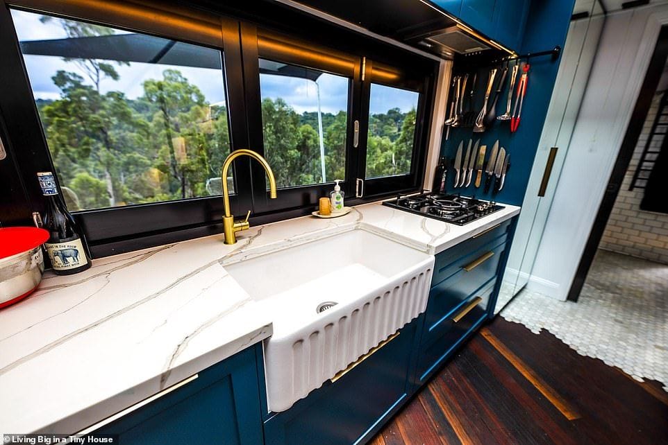 Clean kitchen space inside the DIY tiny home has a slightly industrial feel to it.