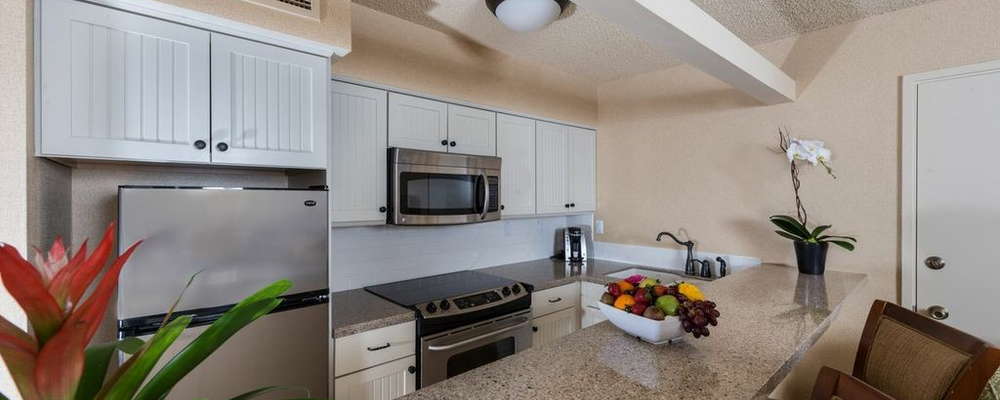 Convenient kitchenette with microwave, stove, oven, refrigerator, dishes and utensils, and coffee-maker