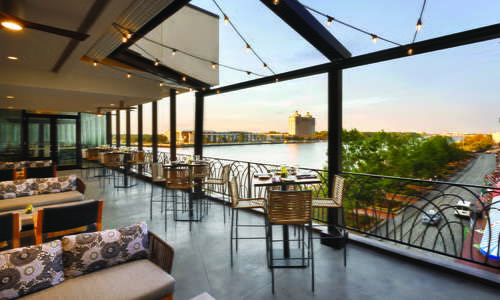 Moss + Oak Savannah Eatery outdoor patio overlooking the Savannah River and River Street.