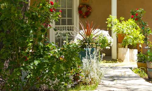 The Rancho de Chimayó Hacienda courtyard surrounded by seven cozy Victorian-style guest rooms.