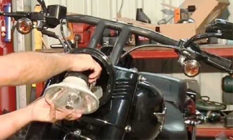 Unplug the wiring harness from the back of the headlamp bulb