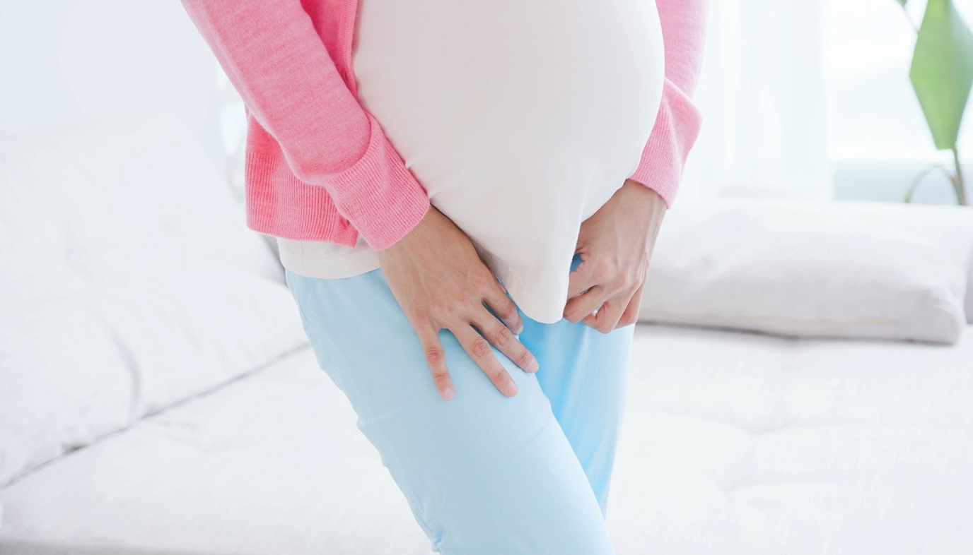 pregnant woman holding her bladder