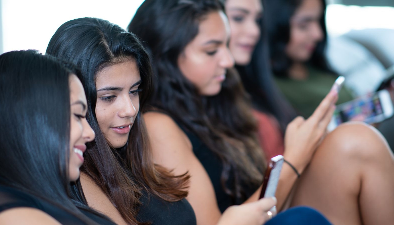 teen girls using cell phones