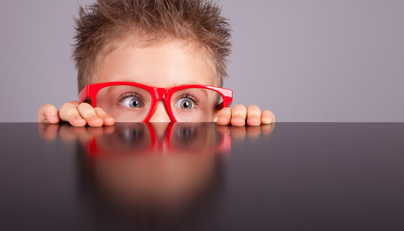 child wearing red glasses