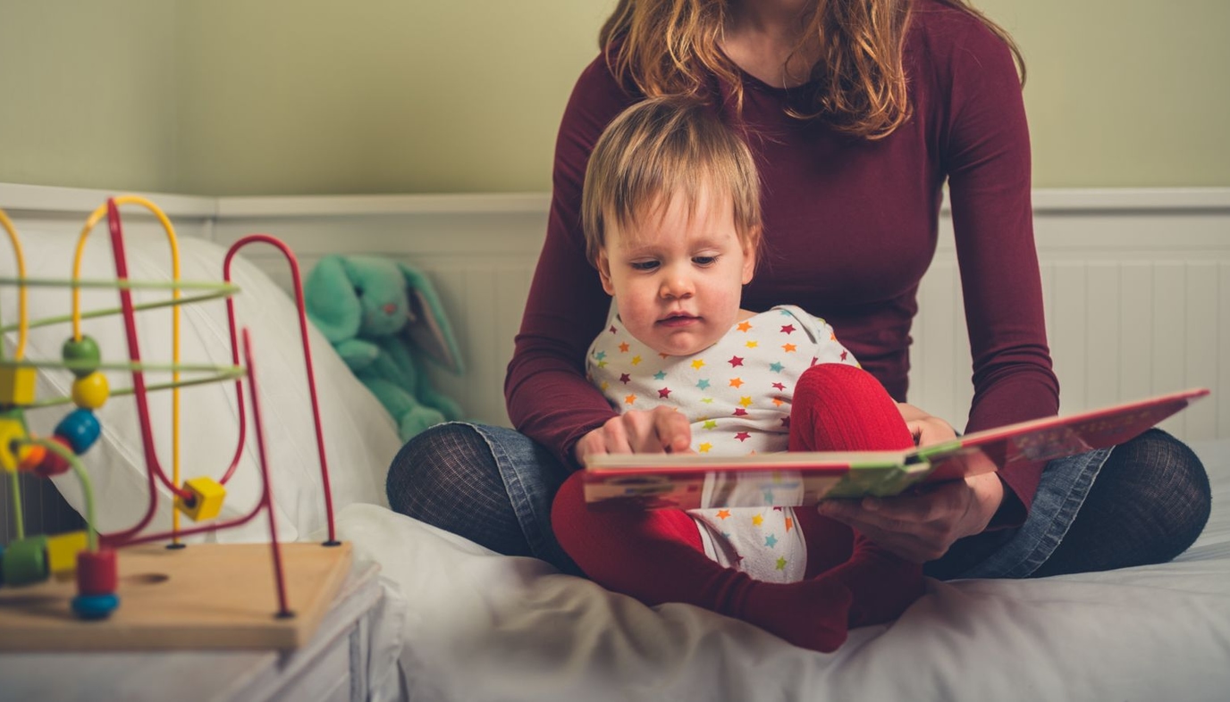 mom reading to toddler son