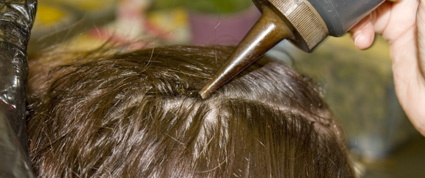 bottle of air dye on scalp