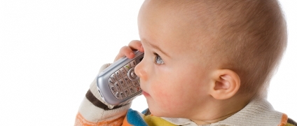 A baby talking on the phone.