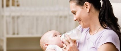 Mommy Tips for Drying up Breast Milk A woman bottle-feeding a baby.