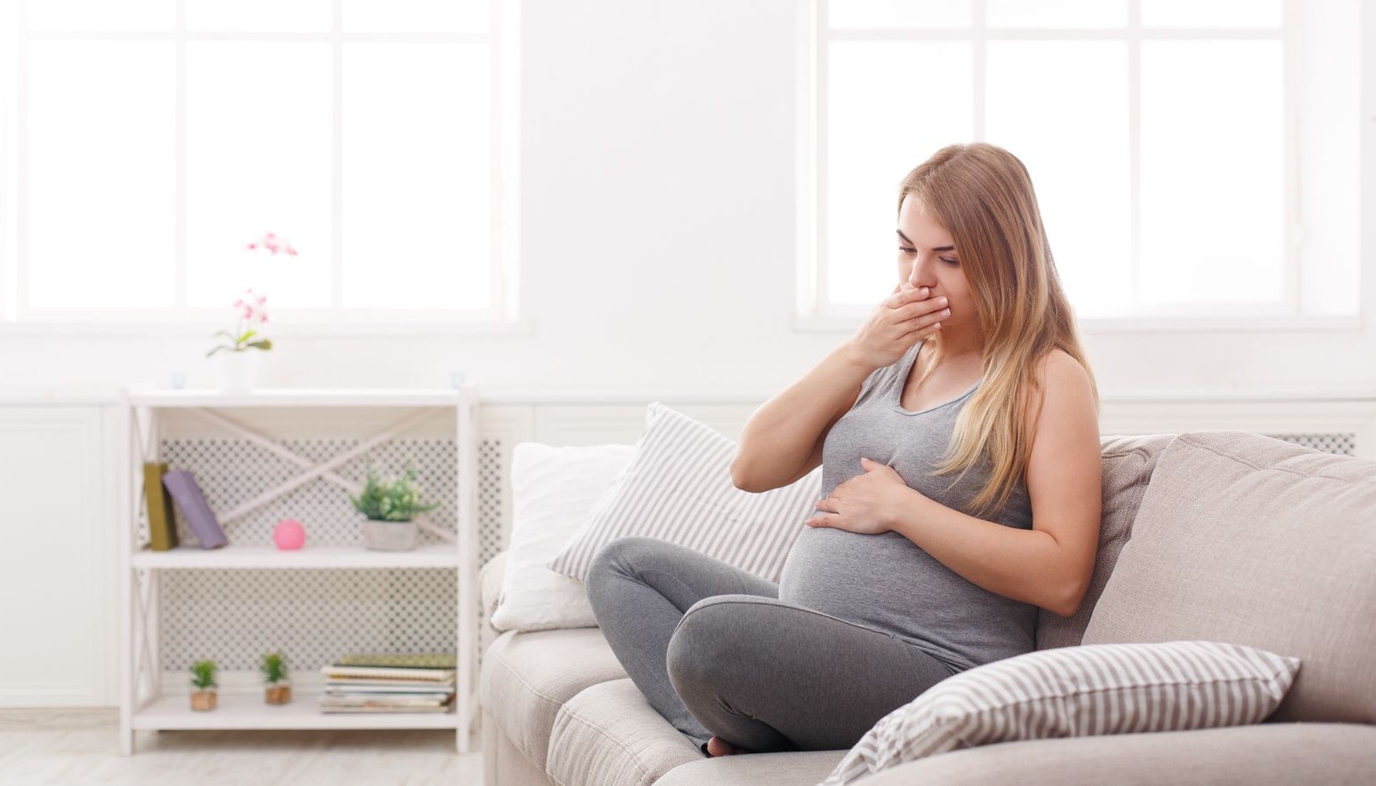pregnant woman having morning sickness