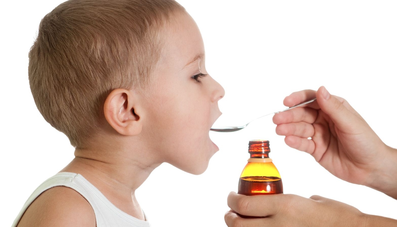 child taking cold medicine