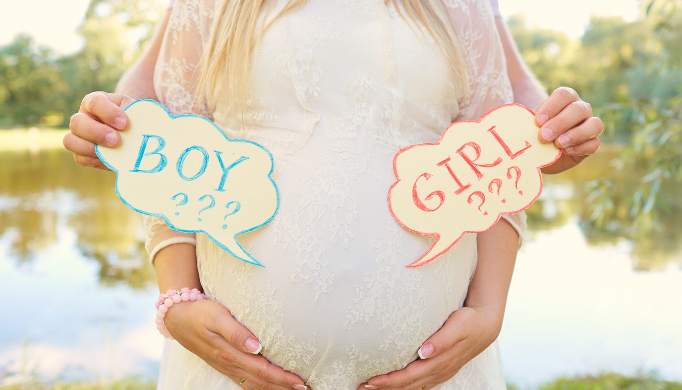 pregnant woman with boy or girl signs