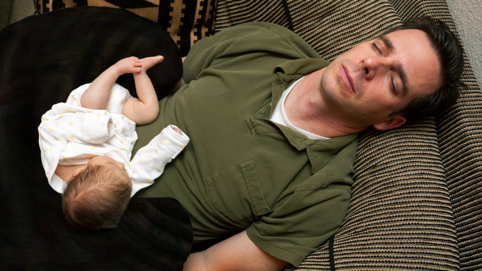 dad sleeping with baby on the couch
