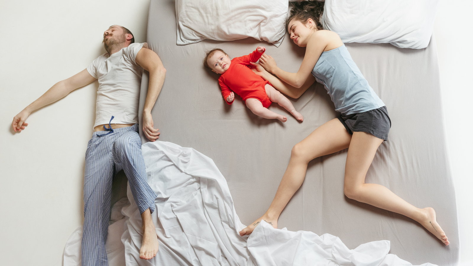 family cosleeping with dad falling off the bed