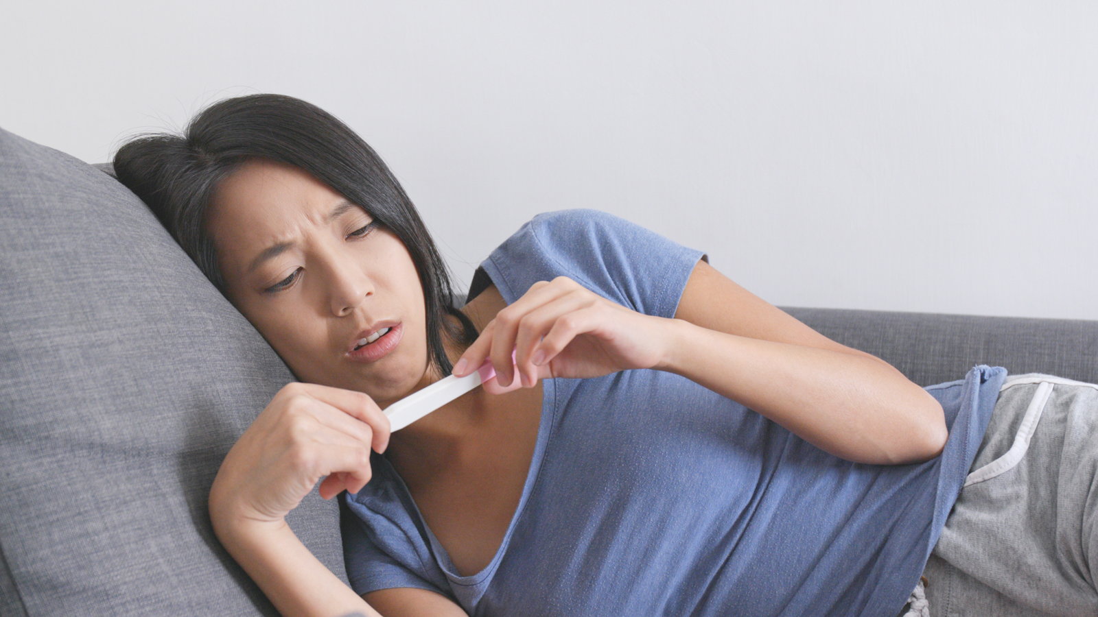 woman looking at negative pregnancy test