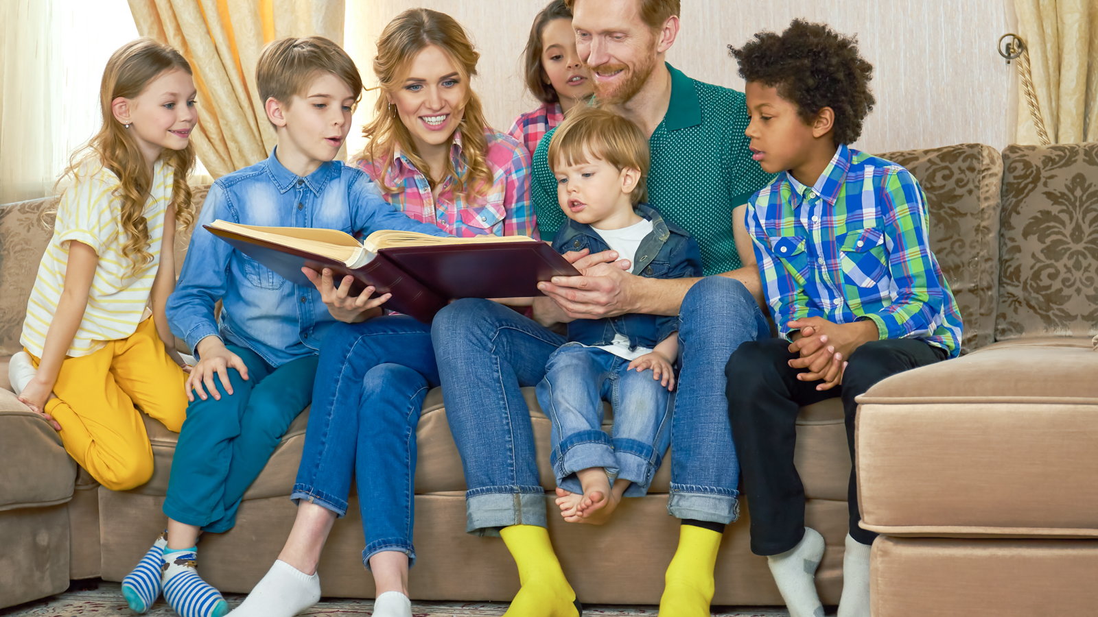 large family reading a book