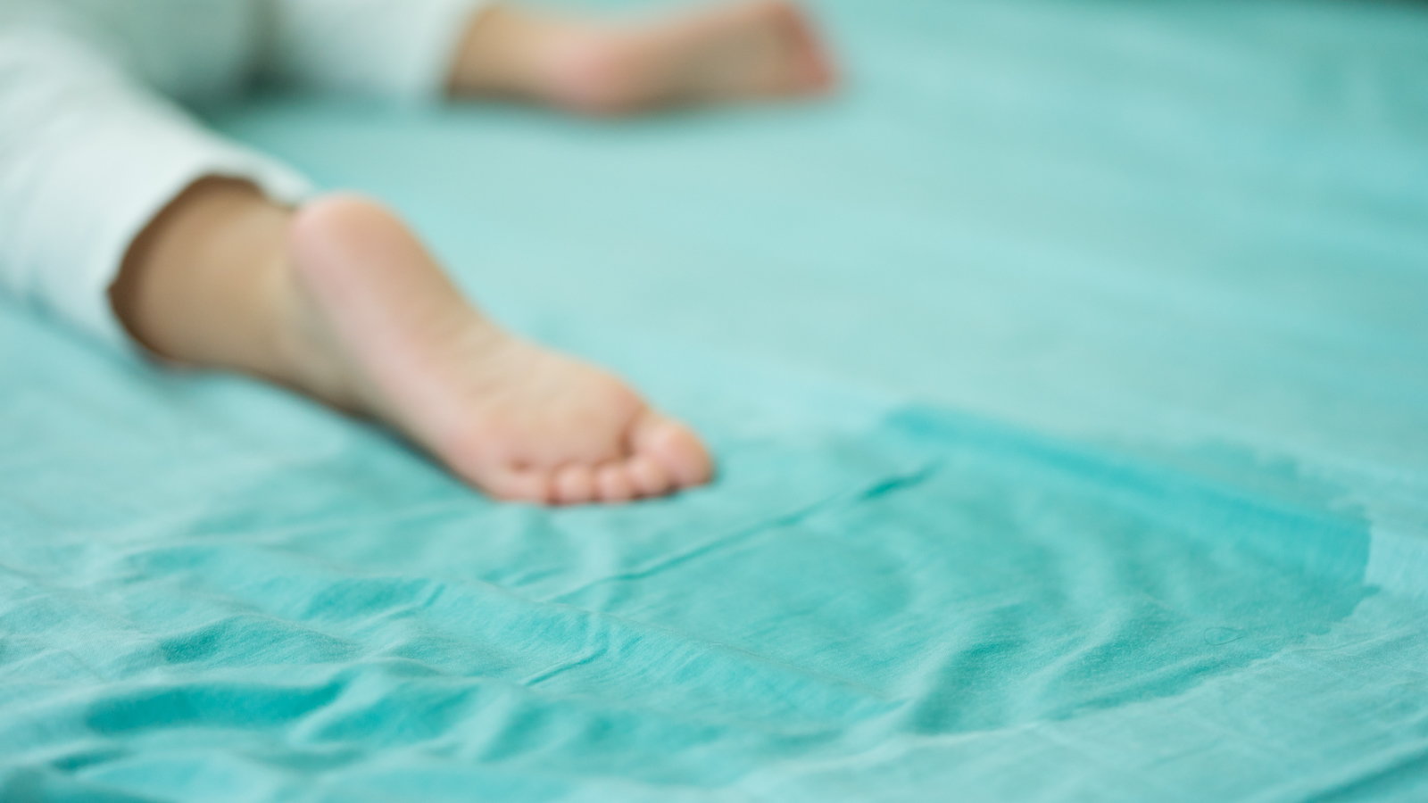 child's foot on wet bed