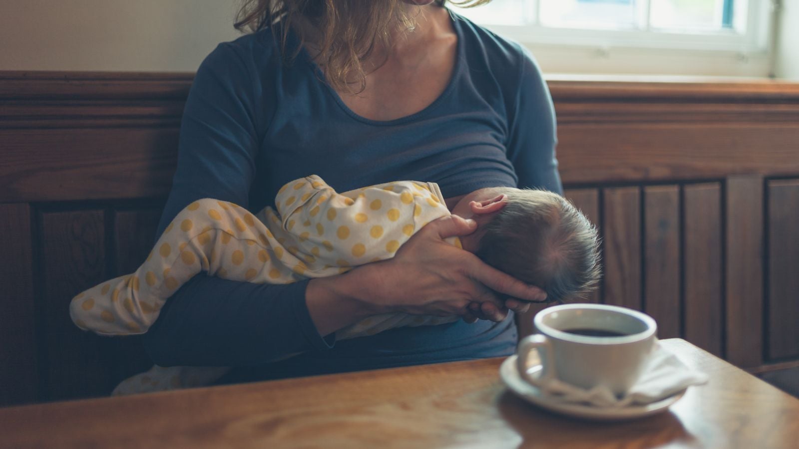 woman breastfeeding in cafe