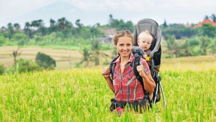 mother wearing baby in a carrier on her back