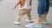 mom helping toddler walk