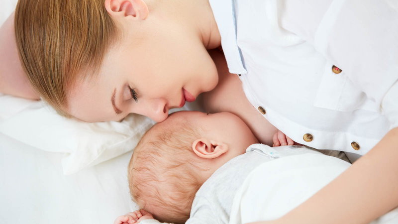 Mom breastfeeding baby while sleeping.