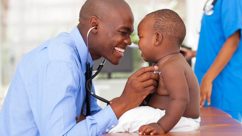 doctor listening to baby's heart with a stethoscope
