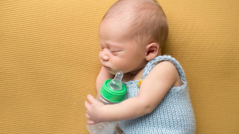 baby holding a baby bottle