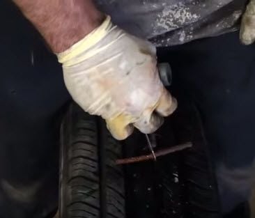 Puncturing tire with plug tool.