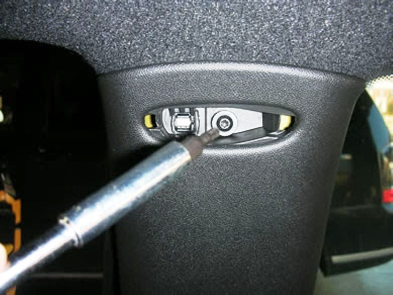 The upper screw on the B-pillar